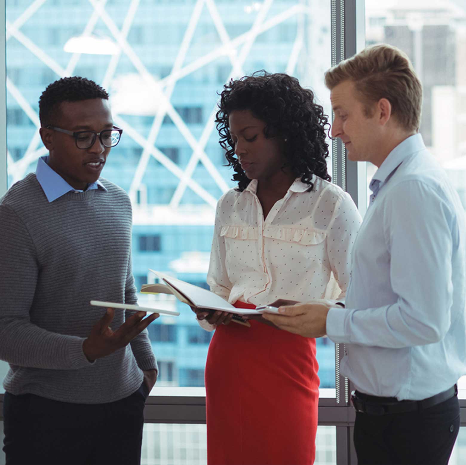 Three business colleagues standing in their office discussing multiple series trusts
